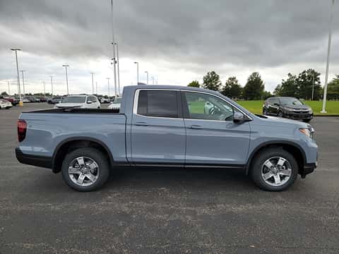 side view of a 2026 Honda Ridgeline truck parked at the Ike Honda dealership in Marion, IL