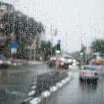rain on a window overlooking a city square