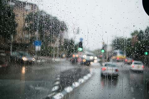 rain on a window overlooking a city square