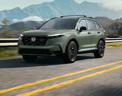 green 2027 Honda CR-V crossover driving down the road