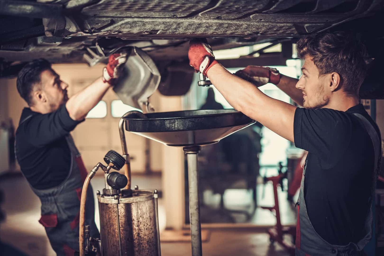 Technicians Changing Car Oil