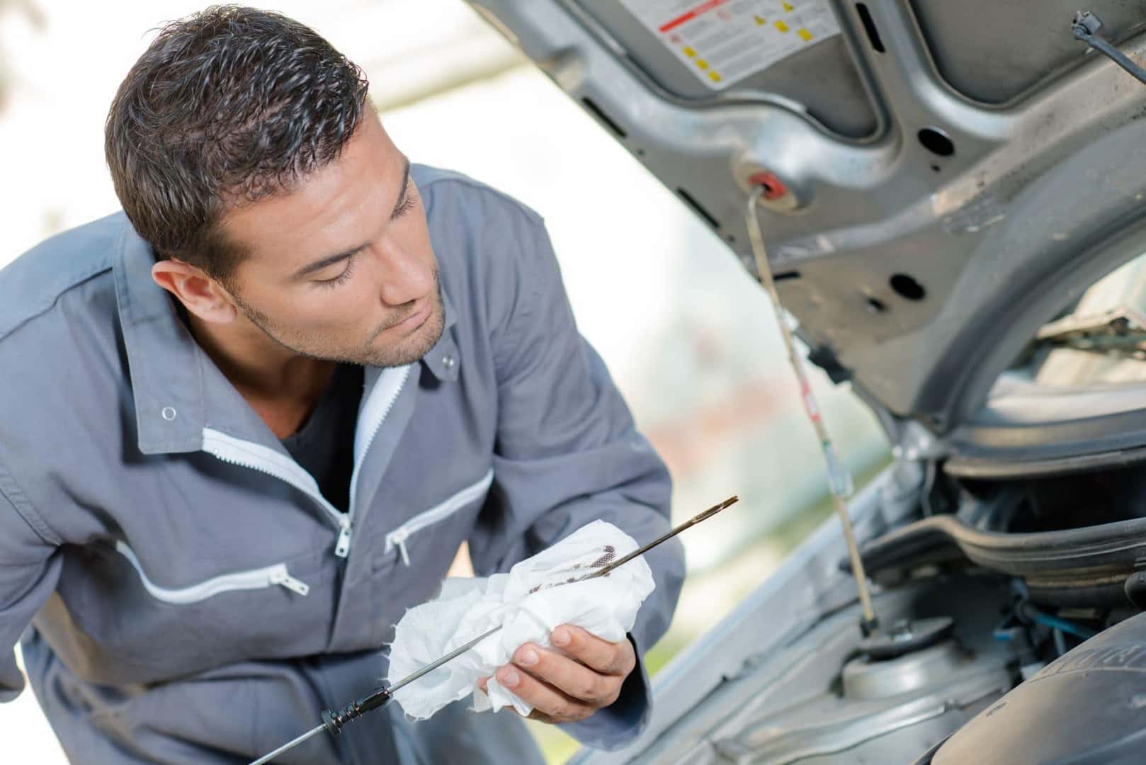 Technician Checking Oil Levels