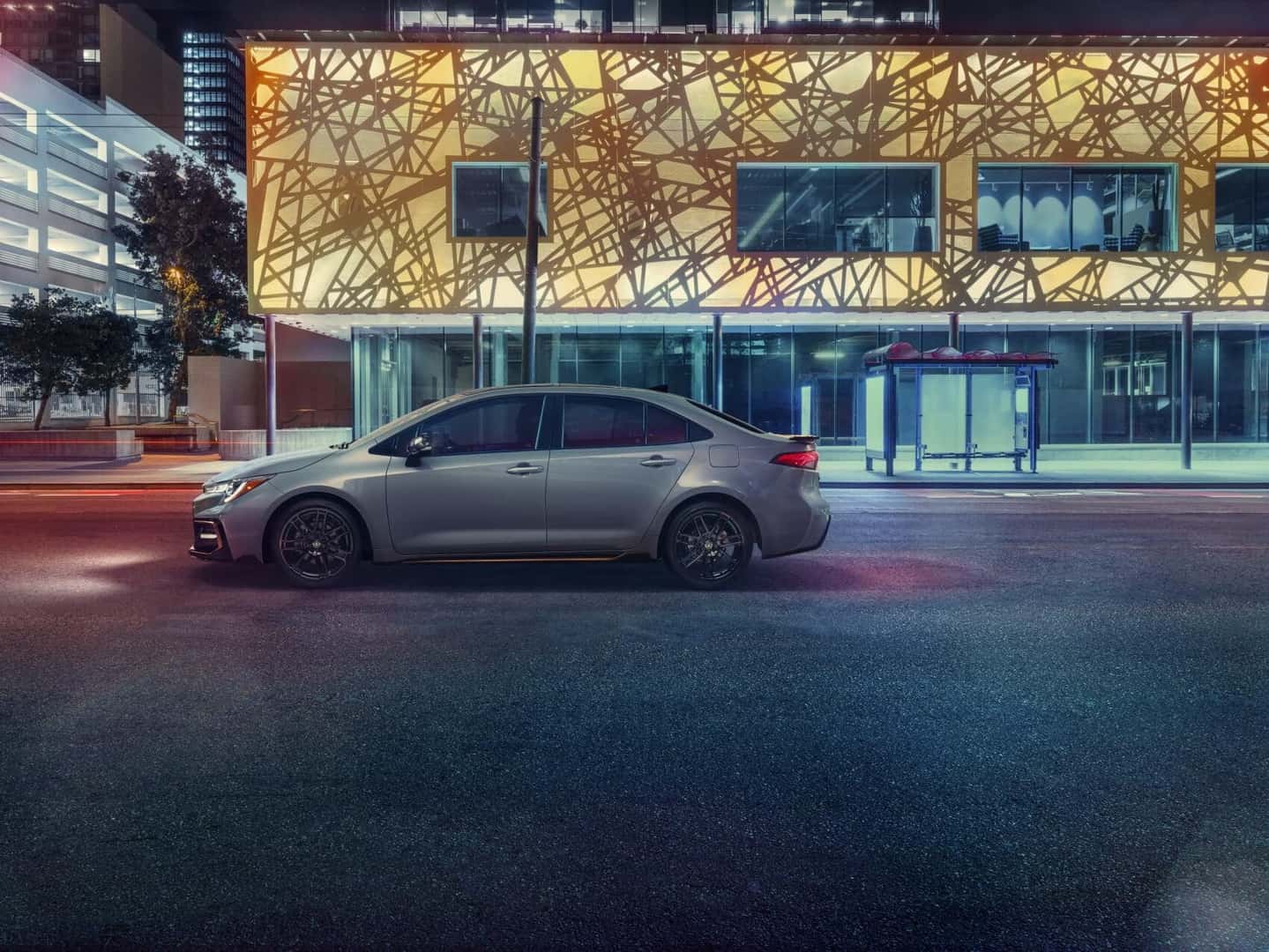 White Toyota Corolla parked in front of building
