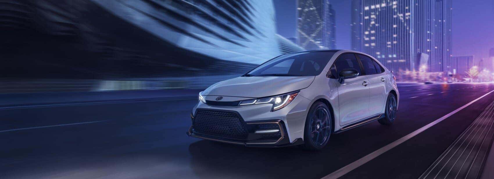 white toyota corolla driving on highway