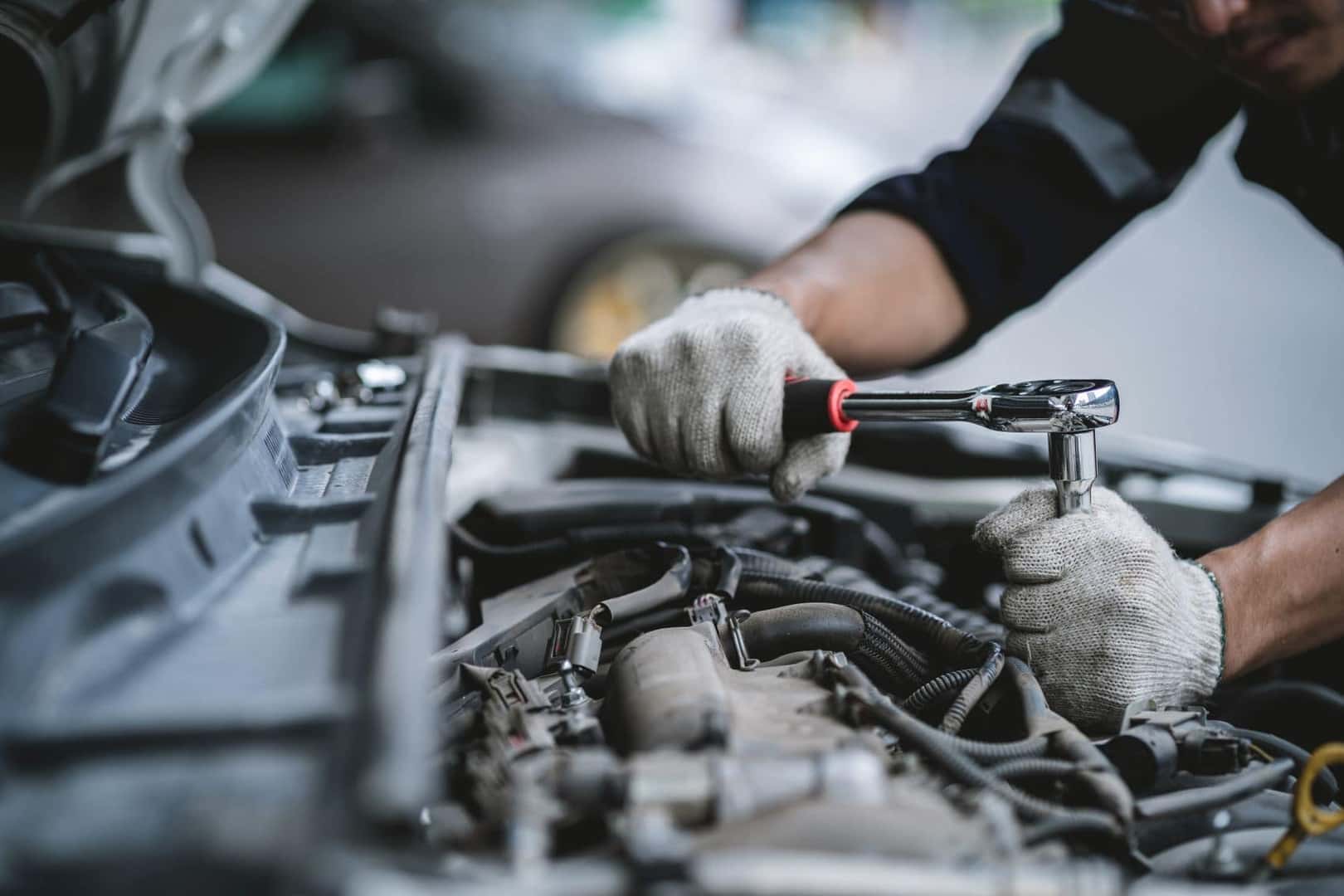 Technician Working Under the Hood