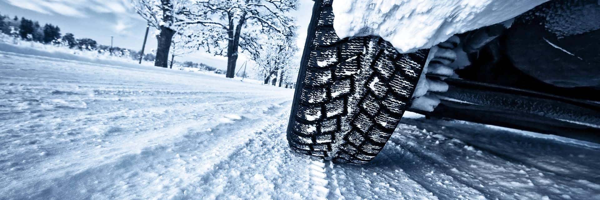 close up of car tires in winter snow