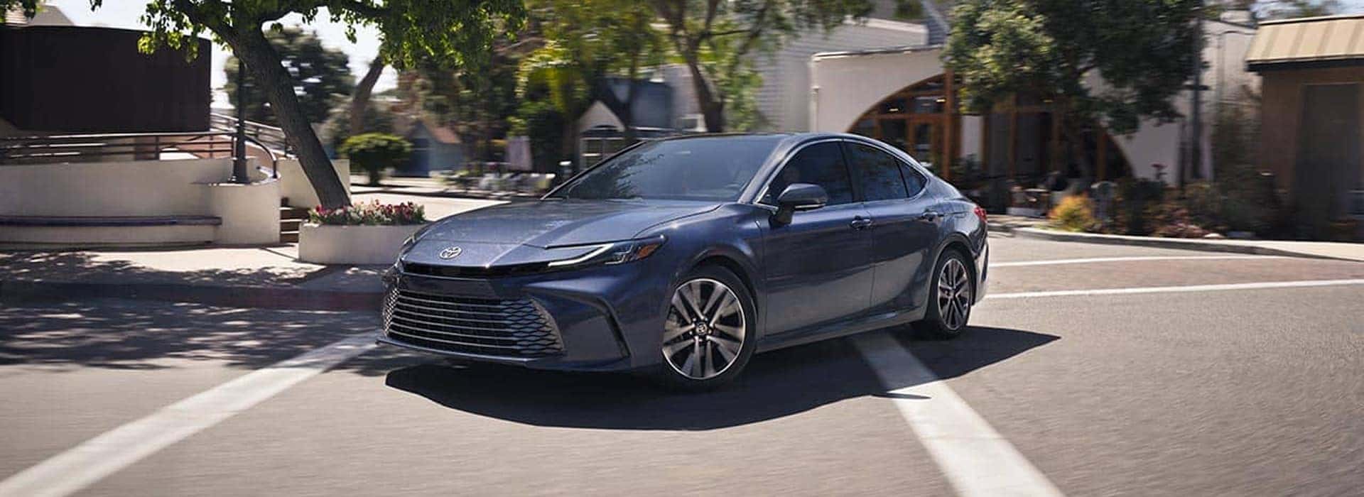 2026 light blue camry driving and turning at a corner