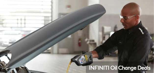 Technician changing oil in INFINITI