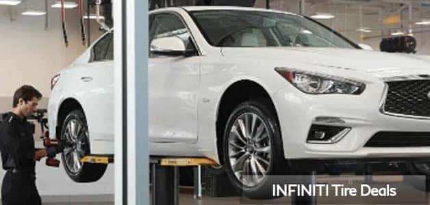 INFINITI Q50 having tires rotated by technician