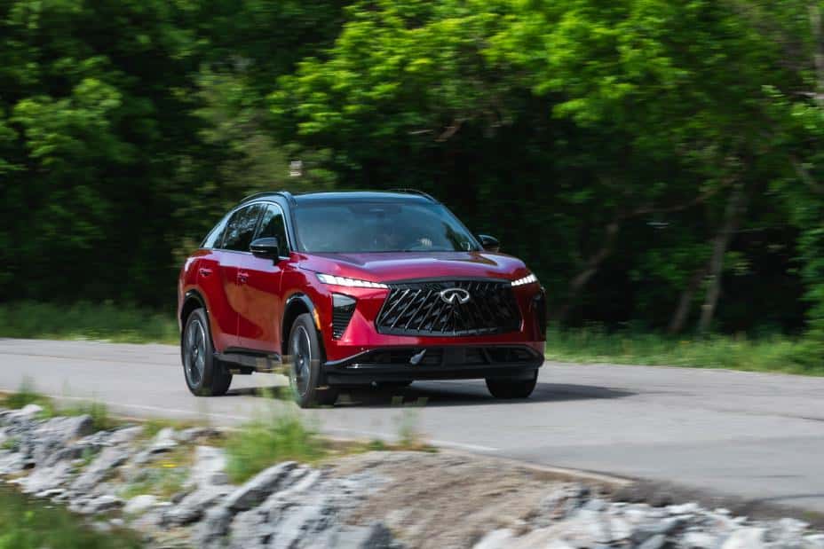 Red QX65 driving down street in spring time
