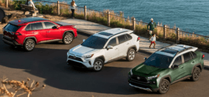 New 2024 Toyota RAV4 Near Kenner, LA shown in Ruby Flare Pearl, Ice Cap, and Army Green with Ice Edge roof.