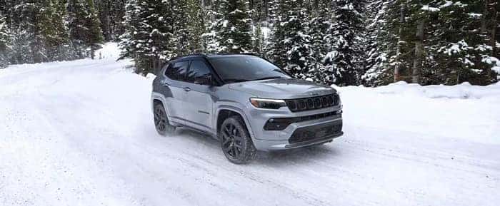 White Jeep Compass driving in the snow