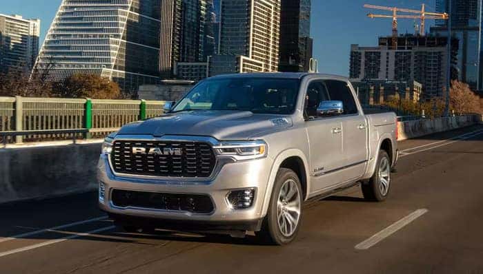 Silver Ram 1500 driving on the street