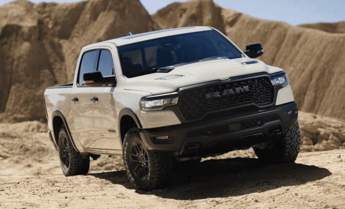 Tan 2025 Ram 1500 Rebel driving off-road