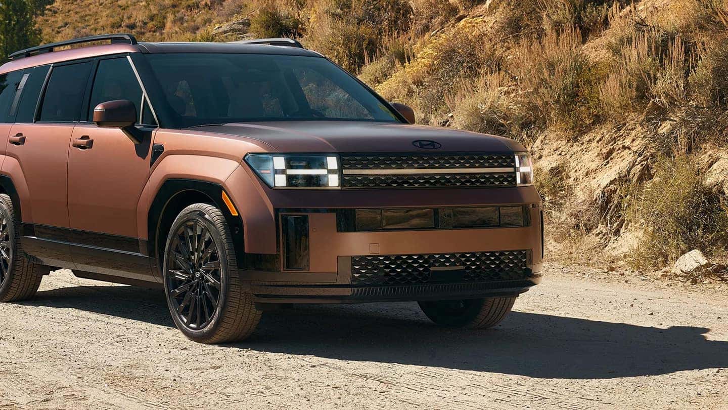 A brown 2024 Hyundai Santa Fe parked on a dirt road