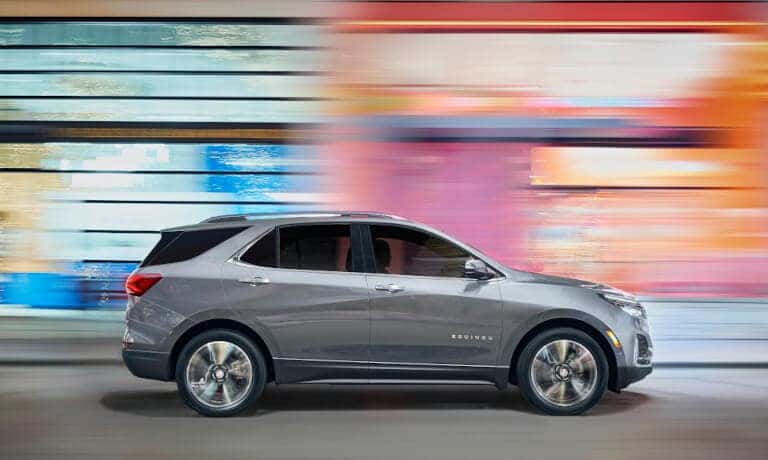 2024 Chevy Equinox Exterior Side Driving Past Colorful Building