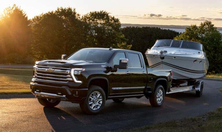 2024 Chevy Silverado 2500 HD Exterior Towing Boat At Sunset