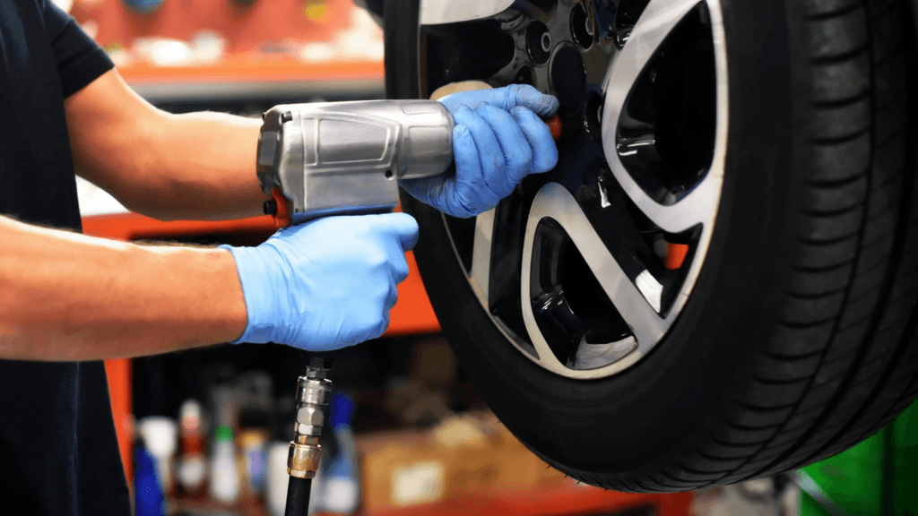A technician performing a tire replacement on a vehicle