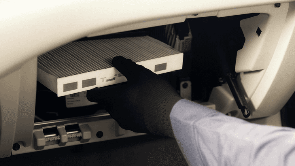 A technician installing a new cabin air filter
