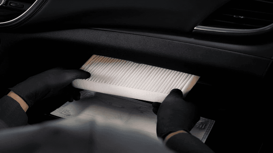 A technician installing a new cabin air filter
