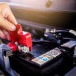 A technician inspecting a car's battery