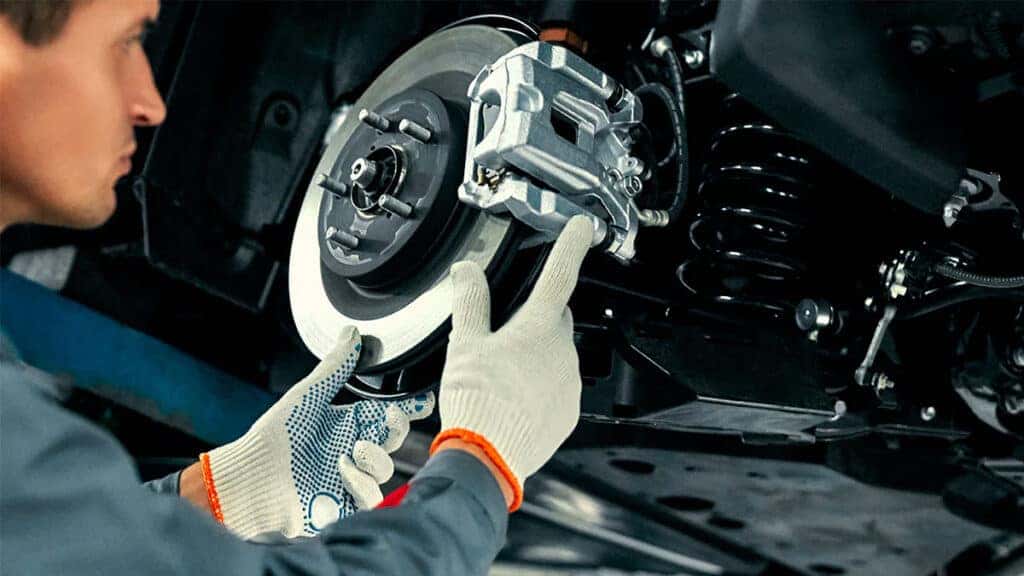 A technician performing brake service on a vehicle