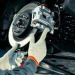 A technician performing brake service on a vehicle