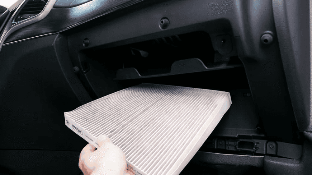 A technician installing a new cabin air filter