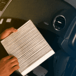 A technician replacing a cabin air filter