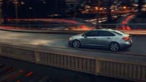 Toyota_Corolla_Driving_In_City_On_Bridge