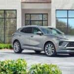 Silver Buick Envision Glass Windows Green Bushes