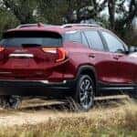 Red GMC Terrain SUV Trees