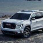 White GMC Acadia SUV Rocks Water
