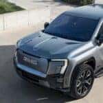 Gray GMC Sierra Denali EV Pickup Truck Green Grass