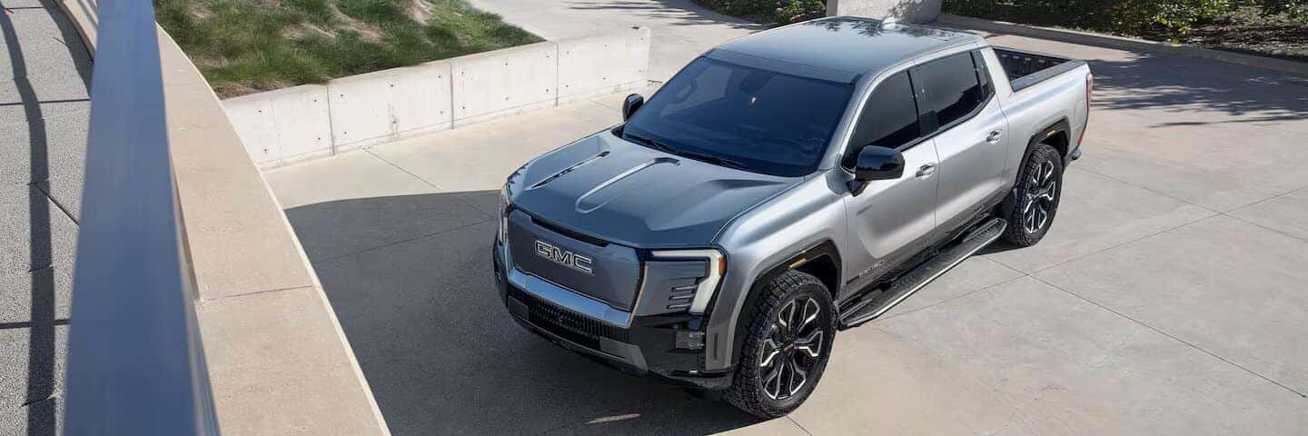 Gray GMC Sierra Denali EV Pickup Truck Green Grass