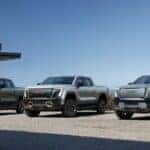Three GMC Silverado EV Pickup Trucks Buildings