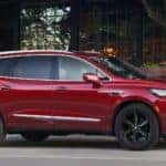 Red Buick Enclave SUV Green Trees