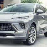 Silver Buick Envision SUV Green Bushes