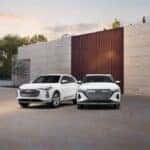 Audi Q5 and Q6 e-tron parked side by side, showcasing their sleek exterior designs and modern styling in a contemporary urban setting.