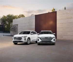 Audi Q5 and Q6 e-tron parked side by side, showcasing their sleek exterior designs and modern styling in a contemporary urban setting.