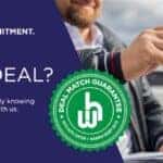 Two people exchanging car keys outdoors, with a bold text overlay that reads 'FOUND A BETTER DEAL?' and a green badge labeled 'Deal Match Guarantee - Keys Auto Center x Warren Henry Auto.' The background includes a blurred car dealership lot and a blue sky