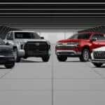 A lineup of six large vehicles that qualify for the over-6,000-pound tax incentive, displayed in a modern tunnel setting. The lineup includes a green Land Rover Defender, a blue Lincoln Navigator, a silver Toyota Tundra, a red Chevrolet Silverado, a white Audi SUV, and a black Lamborghini Urus arranged side by side.