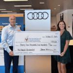 General Manager of Audi Gainesville presenting a $35,500 check to the Ronald McDonald House Charities of Central Florida.