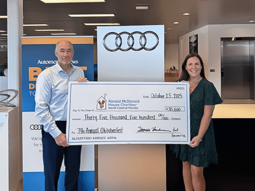 General Manager of Audi Gainesville presenting a $35,500 check to the Ronald McDonald House Charities of Central Florida.