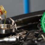 Automotive technician performing an oil service with Keys Auto Center's Service Price Match guarantee graphic displayed alongside the engine bay.