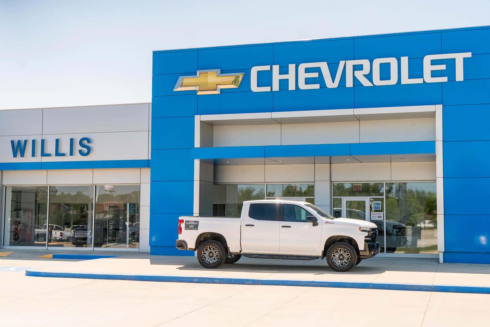 Three Chevrolet Cars lined up outside.